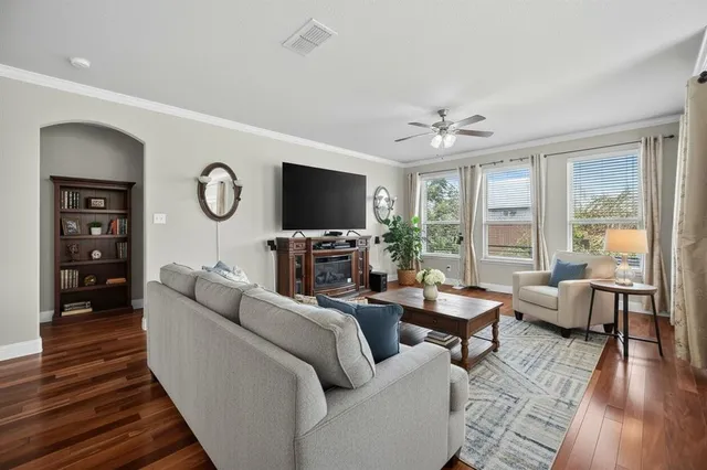 a living room with furniture a fireplace and a flat screen tv