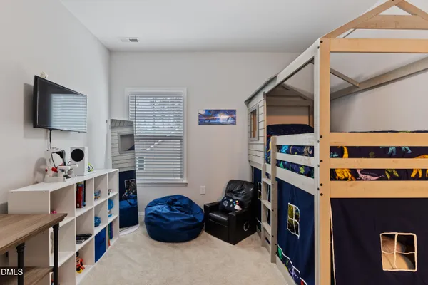a bedroom with a bed and a television
