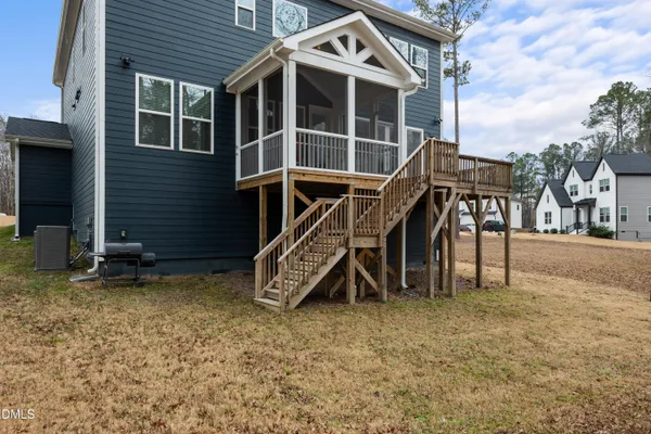 a view of a house with a yard and sitting area