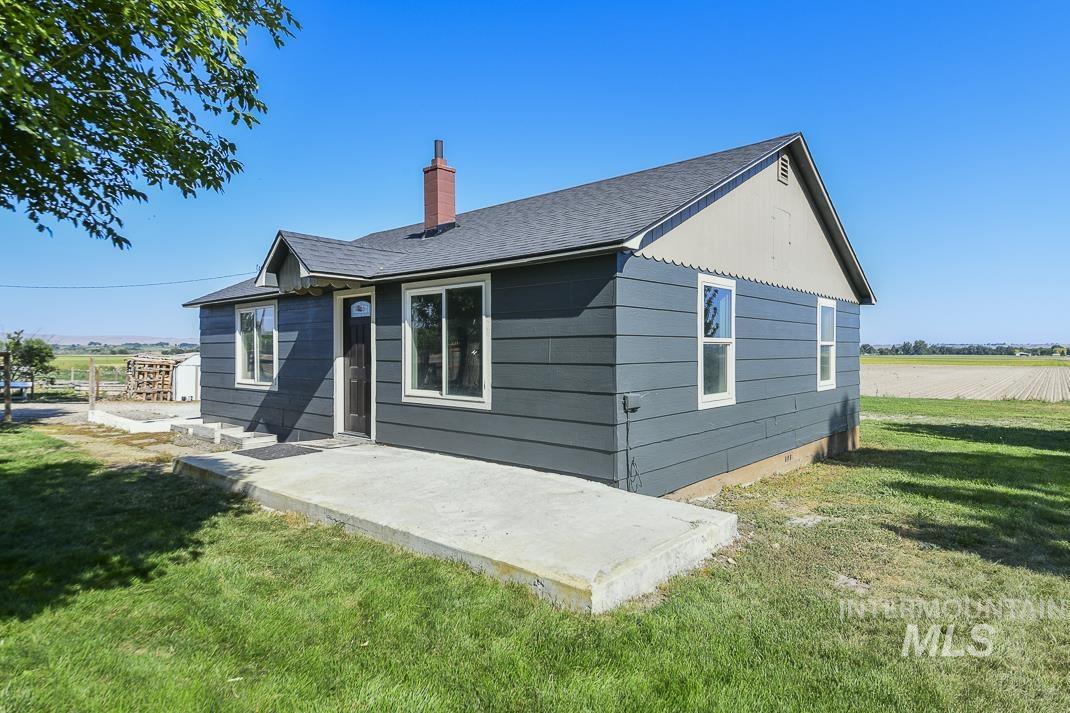 3432 West Pioneer Road Homedale, ID 83628 - Photo 2 of 21 Back of house with a yard, a patio area, a chimney, and roof with shingles