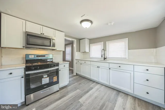 a kitchen with cabinets and appliances