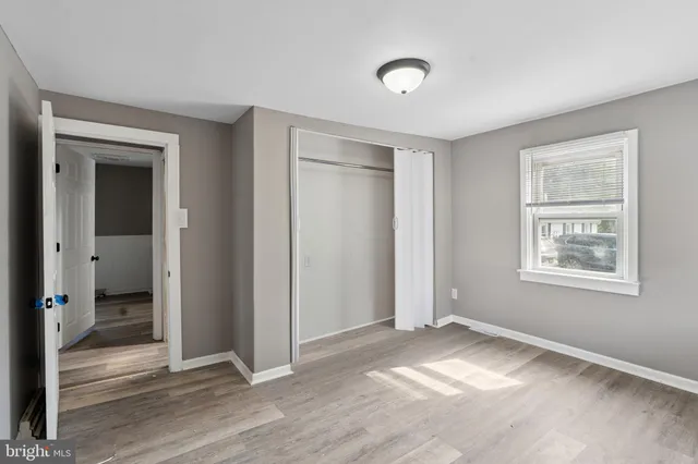 a view of a room with wooden floor and window