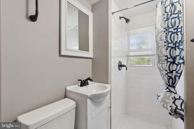a bedroom with a bed and glass windows