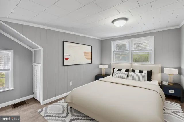 a view of a room with wooden floor and windows