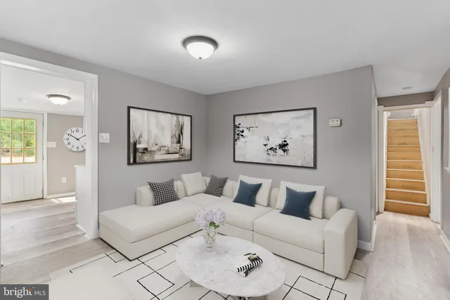 a living room with furniture and a painting