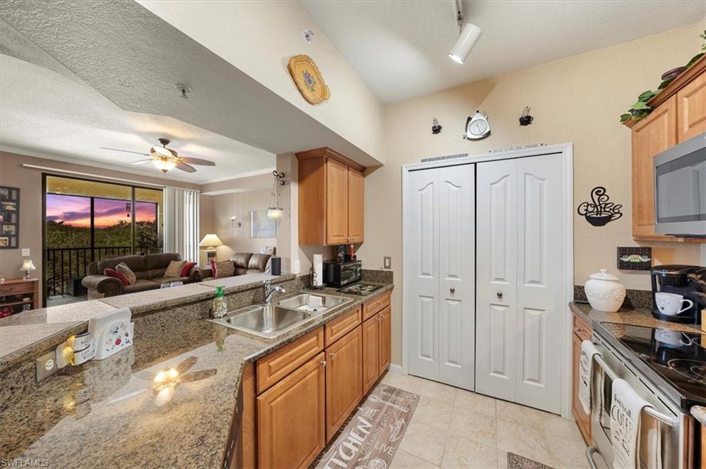 a large kitchen with stainless steel appliances granite countertop a lot of counter space and a sink