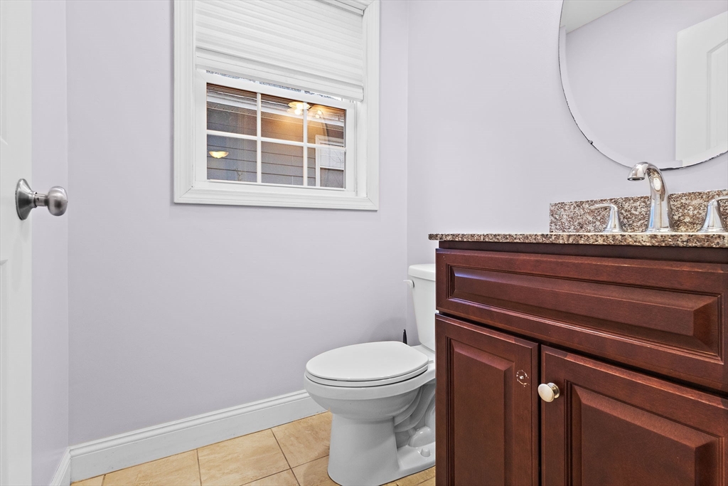 7 Butler Avenue, Unit 5 Lowell, MA 01852 - Photo 13 of 28 a bathroom with a toilet a sink and a mirror