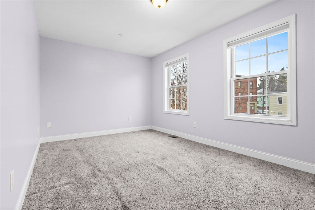 7 Butler Avenue, Unit 5 Lowell, MA 01852 - Photo 14 of 28 an empty room with windows