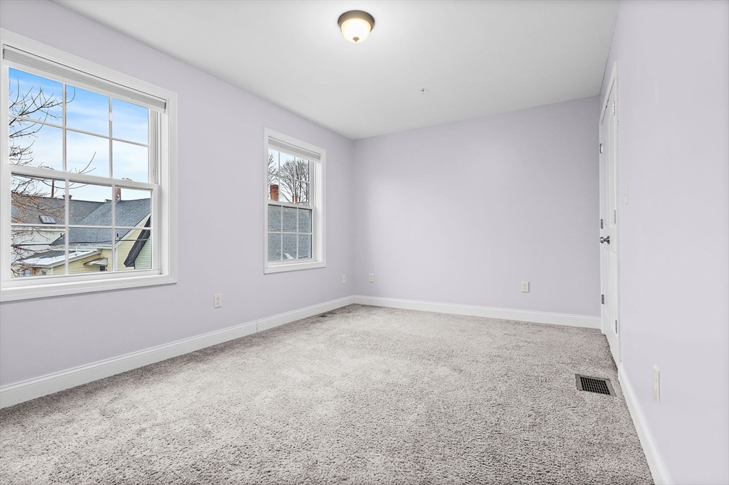 7 Butler Avenue, Unit 5 Lowell, MA 01852 - Photo 16 of 28 an empty room with windows