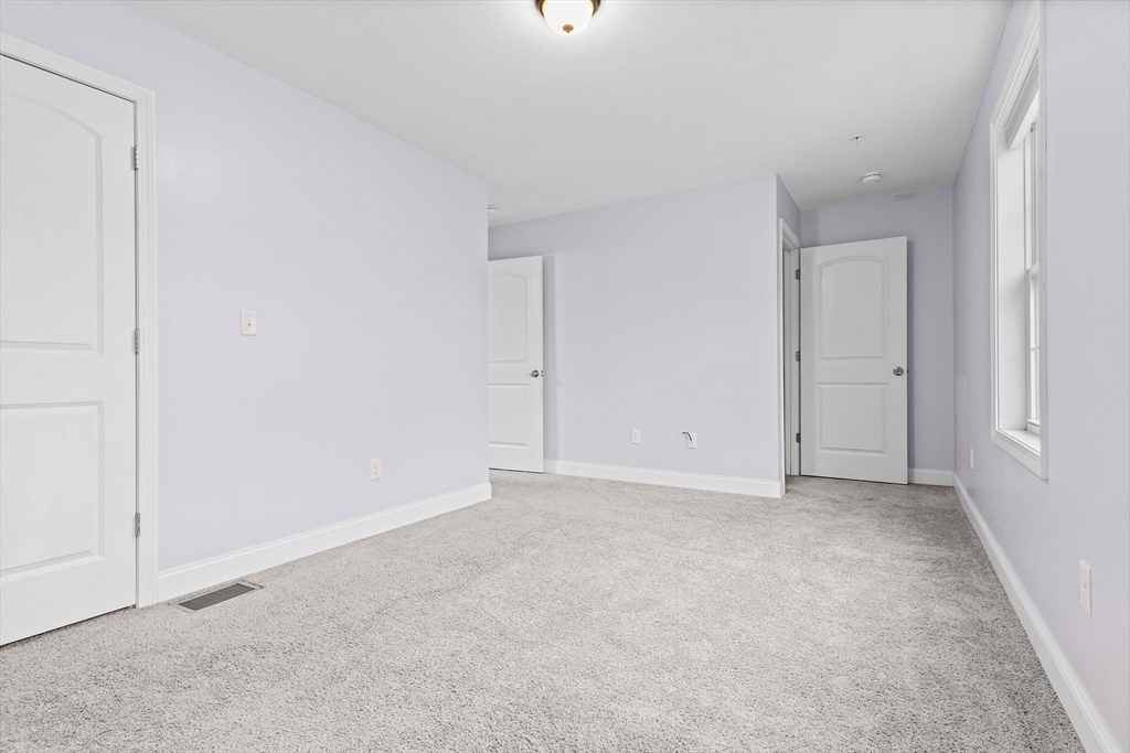 7 Butler Avenue, Unit 5 Lowell, MA 01852 - Photo 17 of 28 a view of an empty room with windows