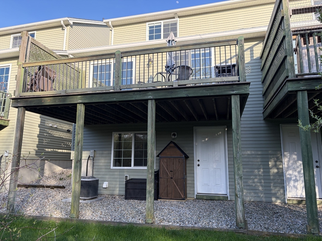 353 Fuller Street, Unit 6 Ludlow, MA 01056 - Photo 11 of 30 a front view of a house with barbeque and stairs