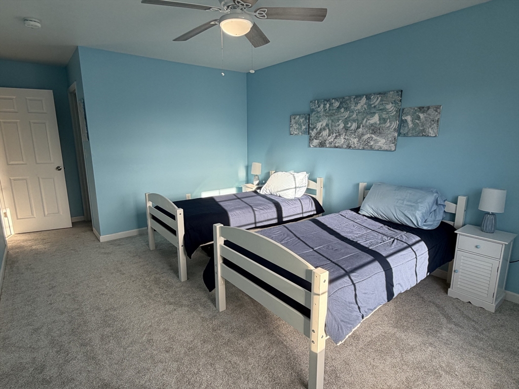 353 Fuller Street, Unit 6 Ludlow, MA 01056 - Photo 16 of 30 a bedroom with bed and a chandelier
