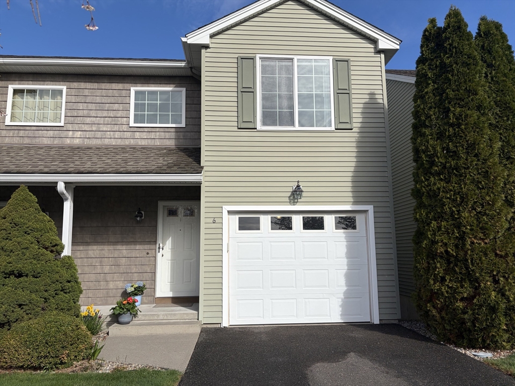 353 Fuller Street, Unit 6 Ludlow, MA 01056 - Photo 2 of 30 a front view of a house with a yard