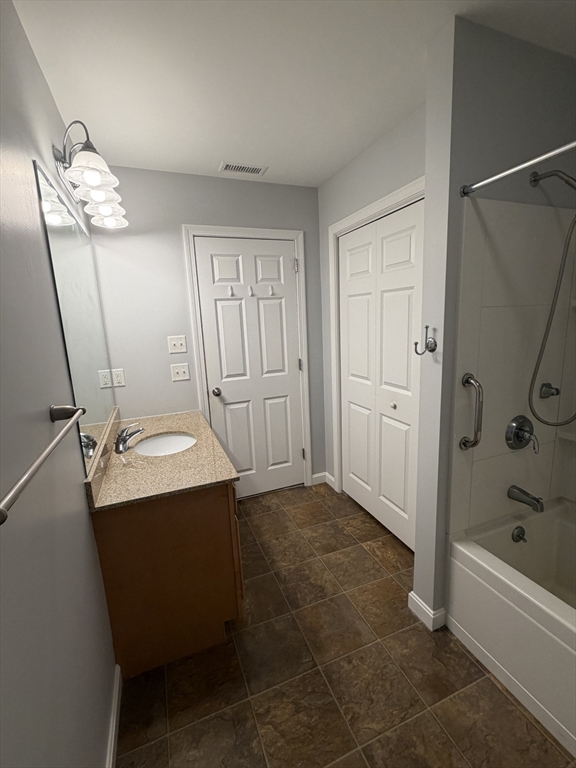 353 Fuller Street, Unit 6 Ludlow, MA 01056 - Photo 21 of 30 a bathroom with a sink a mirror and a bathtub