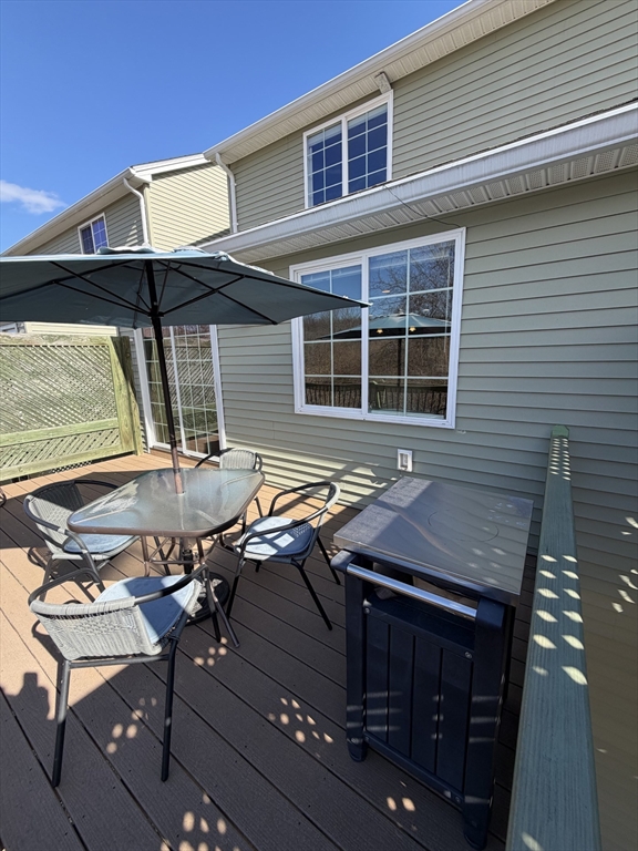 353 Fuller Street, Unit 6 Ludlow, MA 01056 - Photo 3 of 30 a patio with table and chairs