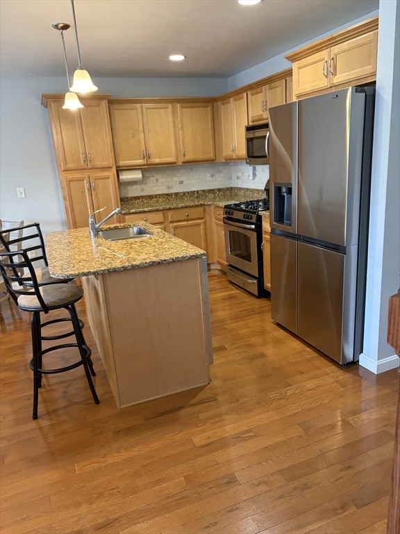 353 Fuller Street, Unit 6 Ludlow, MA 01056 - Photo 8 of 30 a kitchen with stainless steel appliances granite countertop a refrigerator a stove a sink and a refrigerator