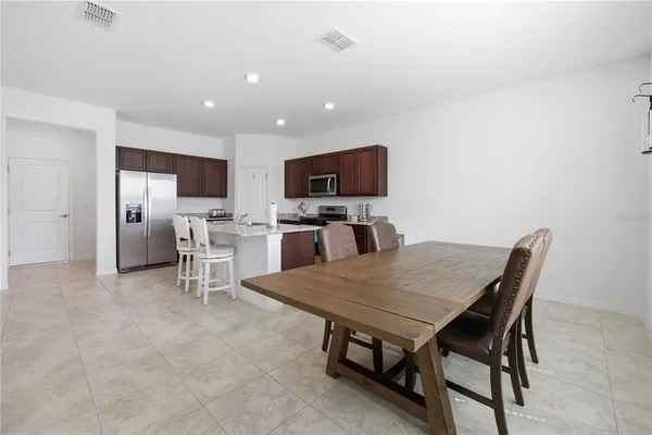 a kitchen with a table and chairs in it