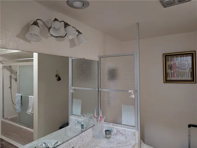 a bathroom with a shower sink and mirror