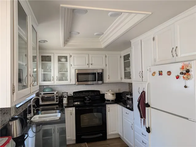 a kitchen with stainless steel appliances a stove a sink and a refrigerator