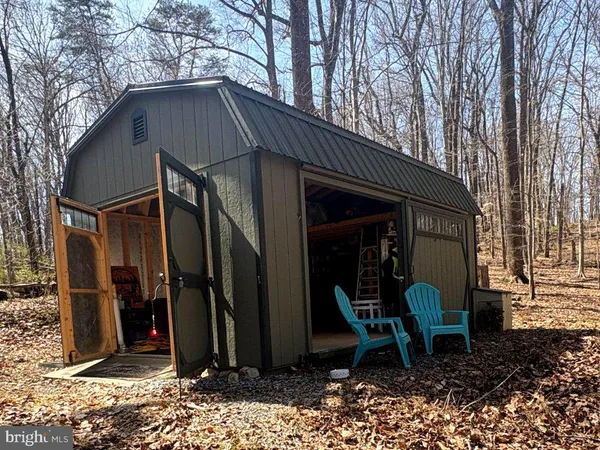 a view of a chair and table in backyard