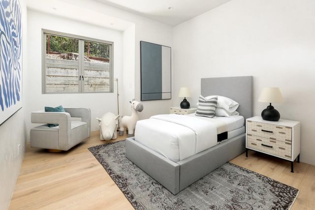 a bedroom with a bed and window