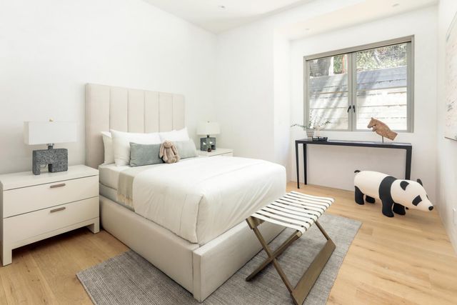 a bedroom with bed and a night stand