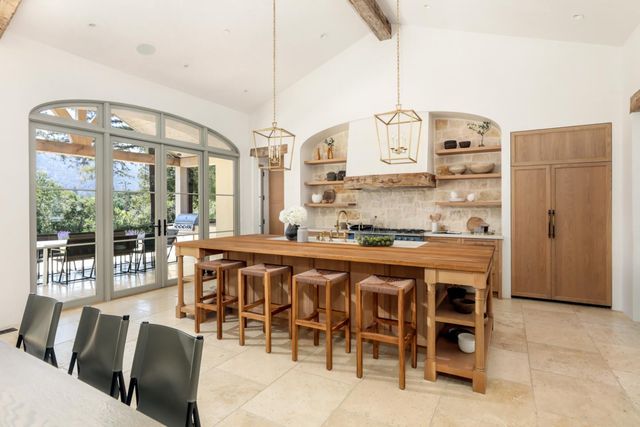 a large kitchen with a table and chairs