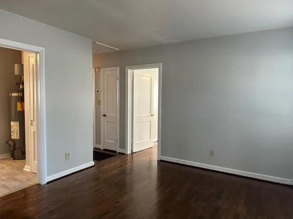 an empty room with wooden floor and closet