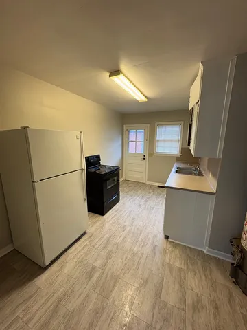 a room with furniture and a refrigerator