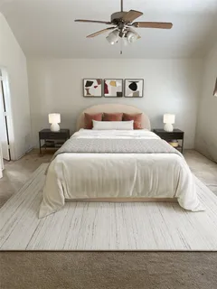 a bedroom with a bed and painting on the wall