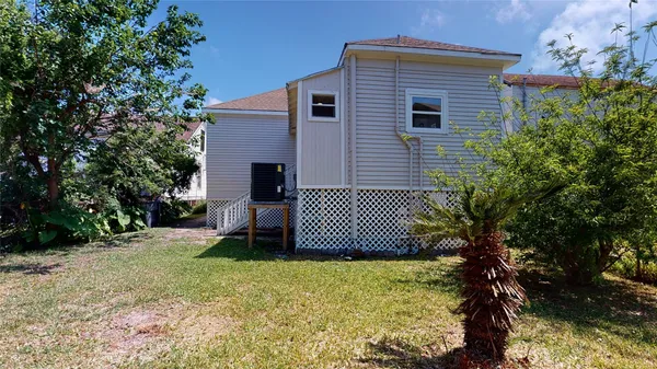 a view of a house with a yard and deck