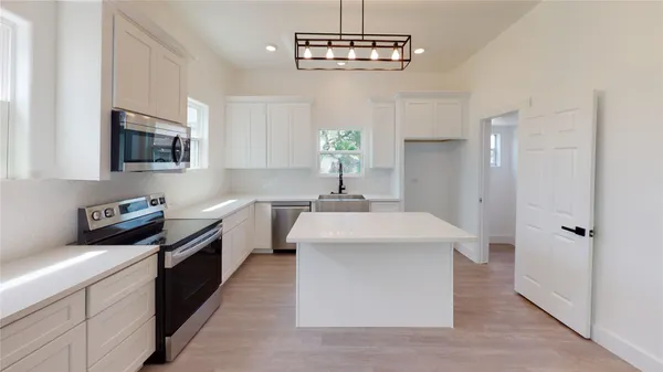 a kitchen with a sink stainless steel appliances and cabinets