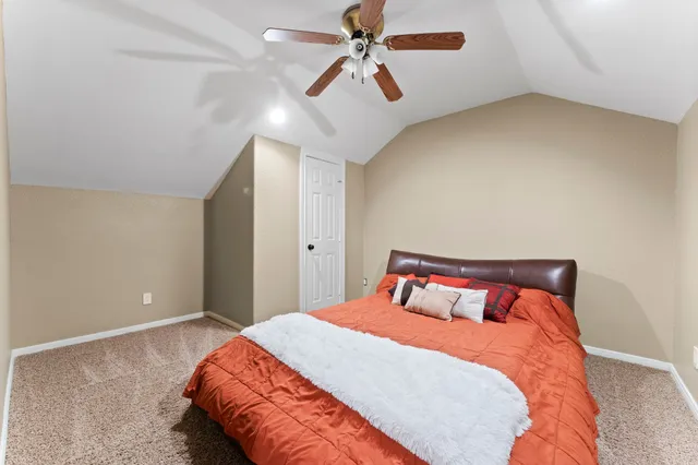 a bedroom with a bed and ceiling fan