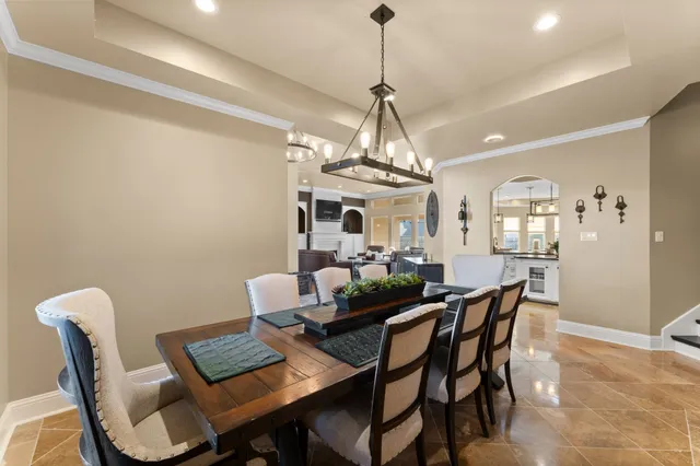 a view of a dining room with furniture and chandelier