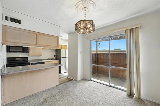a kitchen with a stove a microwave and cabinets