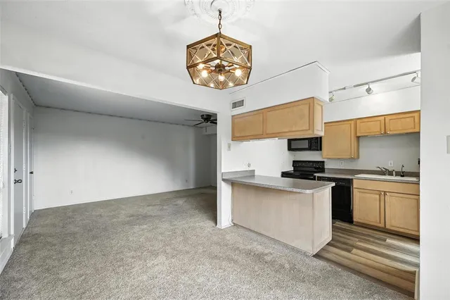 a kitchen with stainless steel appliances a stove a refrigerator and a sink