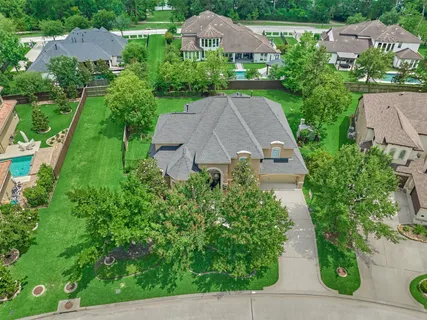 an aerial view of a house with yard and green space