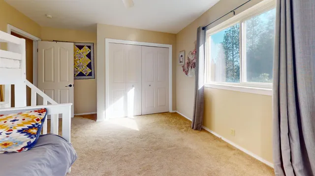 a view of an empty room with toys and a window