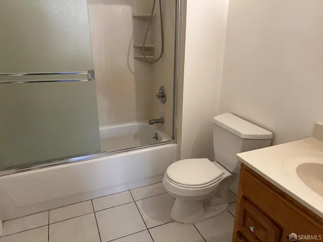 a white toilet sitting next to a bath tub