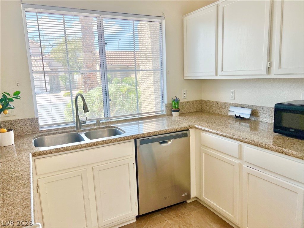 9708 Ridge Creek Place Las Vegas, NV 89134 - Photo 10 of 34 Prepare meals in this kitchen, boasting dual stainless-steel sinks and generous countertop space.