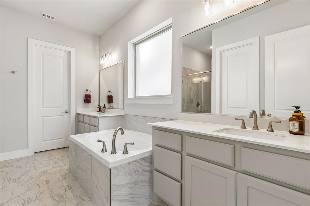 3004 Windy Rdg Road McKinney, TX 75071 - Photo 14 of 40 a bathroom with a bathtub and a sink
