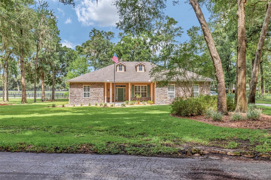 1989 Northwest 111th Loop Ocala, FL 34475 - Photo 1 of 55 a front view of a house with a yard