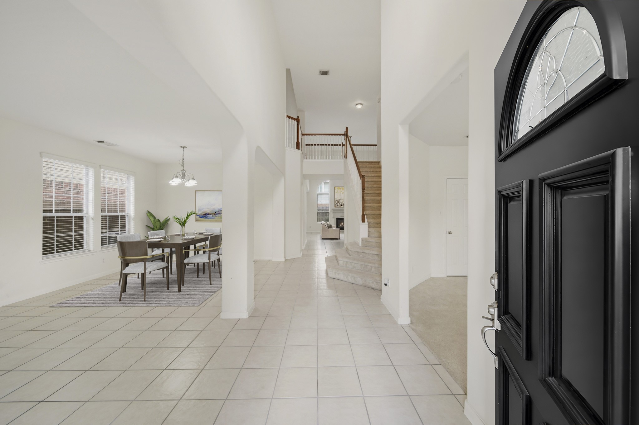 3306 Colleville Sur Mer Lane Spring, TX 77388 - Photo 3 of 30 Welcome home! The tile flooring throughout enhance the home's timeless appeal, while the open layout provides effortless flow between spaces. The grand staircase and soaring entryway add a sense of elegance, making this area a stunning focal point of the home.