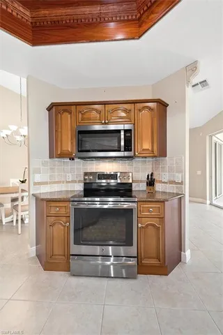 a kitchen with stainless steel appliances white cabinets and a stove top oven