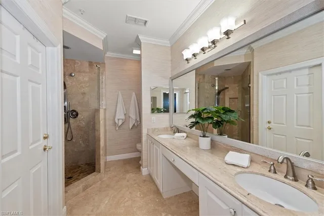 a bathroom with a granite countertop double vanity sink mirror and shower