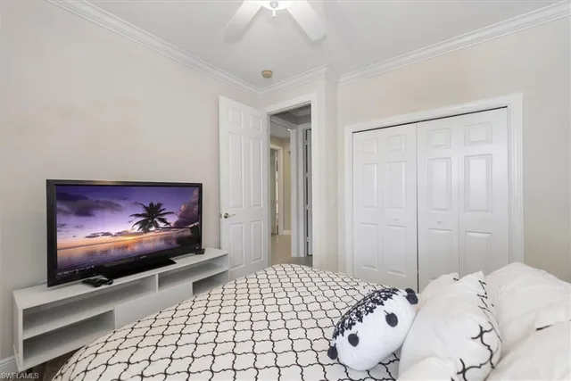 a bedroom with a bed and a flat screen tv