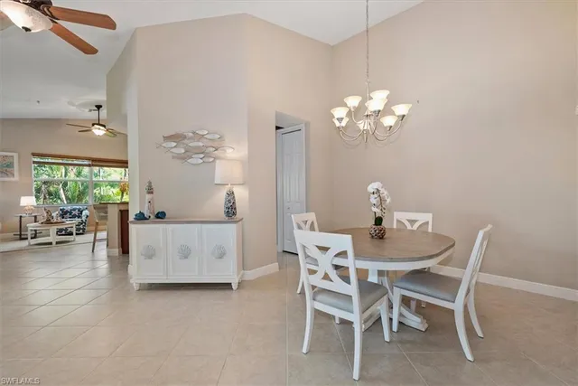 a dining room with furniture and chandelier