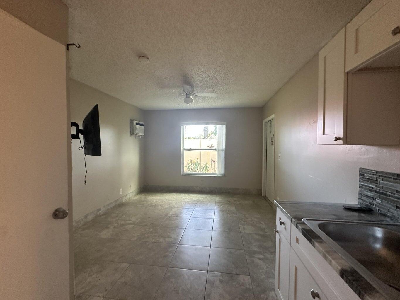 300 Northeast 42nd Street Boca Raton, FL 33431 - Photo 12 of 53 a kitchen that has a sink and a stove
