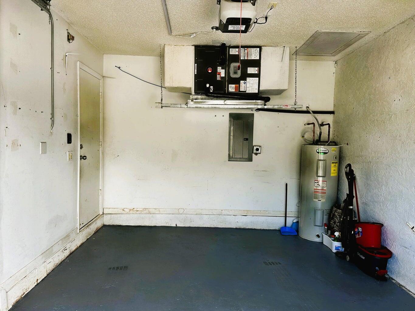 300 Northeast 42nd Street Boca Raton, FL 33431 - Photo 22 of 53 a room with water heater and wooden cabinets