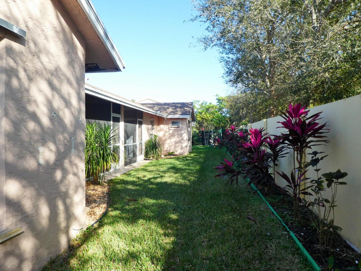 300 Northeast 42nd Street Boca Raton, FL 33431 - Photo 23 of 53 a backyard of a house with lots of green space
